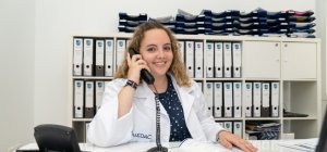 Técnica en Documentación Sanitaria atendiendo llamadas en una oficina sanitaria