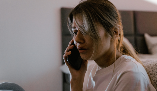 Mujer con actitud preocupada llamando por teléfono a emergencias